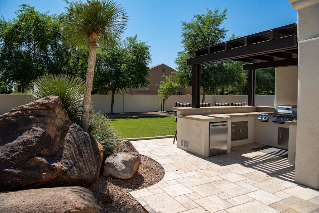 Outdoor kitchen design with built-in-grill and functional entertaining space